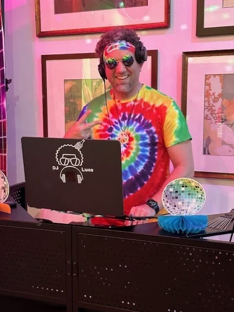 DJ Luce performing in colorful party attire